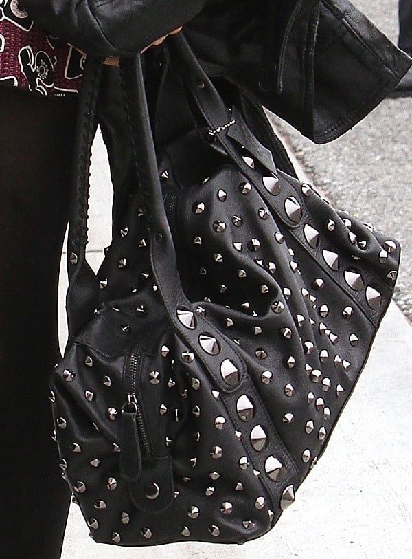 Paris Hilton toting a studded handbag