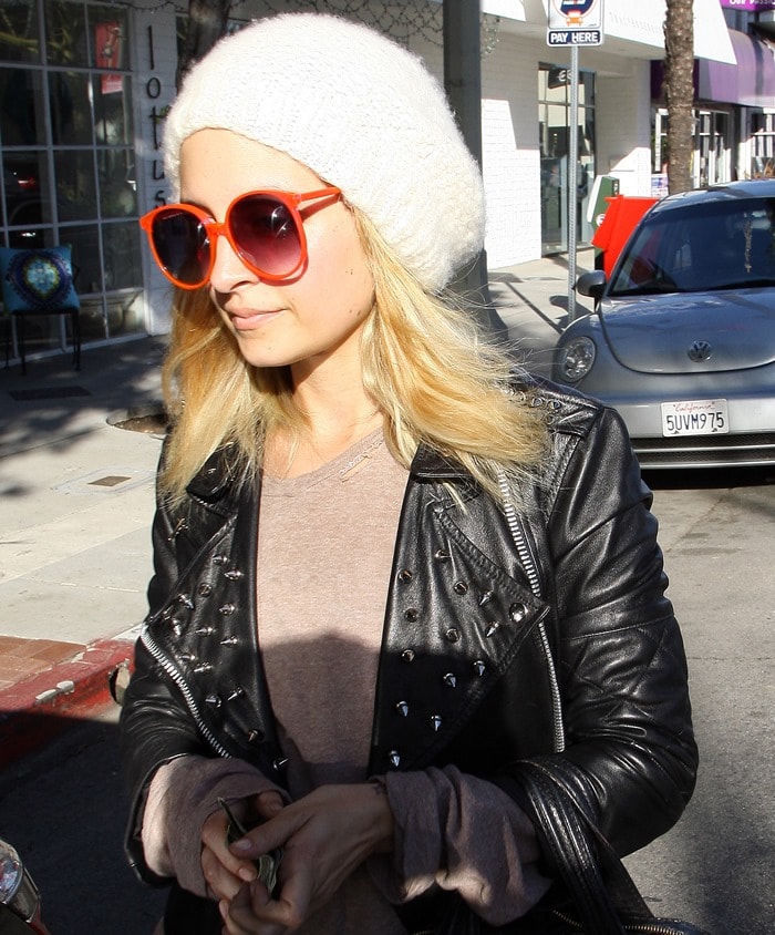 Nicole Richie wearing retro red sunnies and a beanie