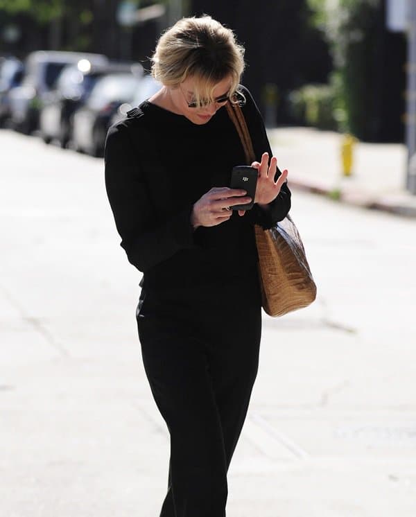 Renee Zellweger is seen using her Blackberry after leaving the Kate Somerville Skin Health Experts Clinic