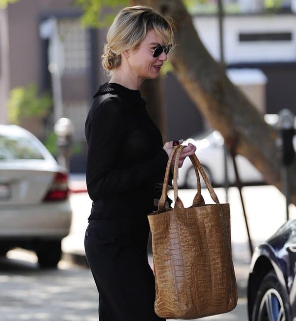 Renee Zellweger toting a lovely luggage brown colored tote