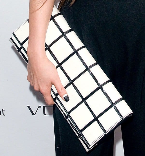 China Chow toting a checkered black and white oversized clutch