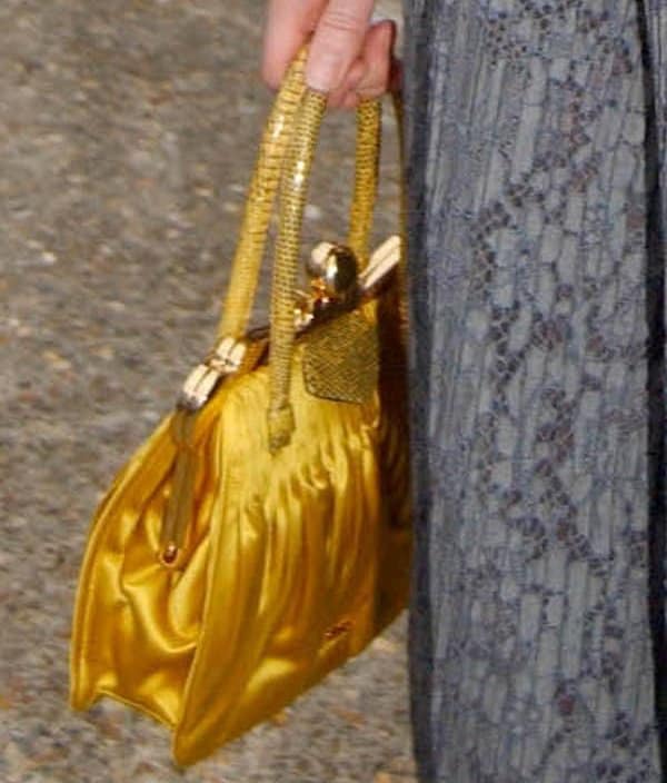 Bonnie Wright toting a Miu Miu pleated satin and Tejus frame bag in bright yellow