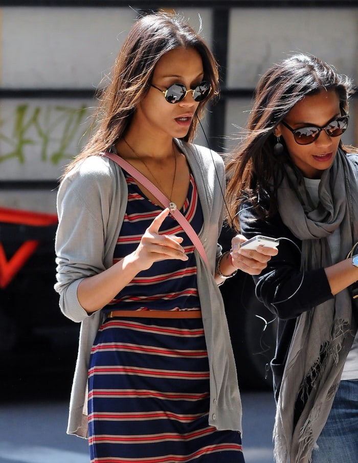 Zoe Saldana sharing an earbud headphone on an iPod with a friend while out and about in Manhattan on May 11, 2012