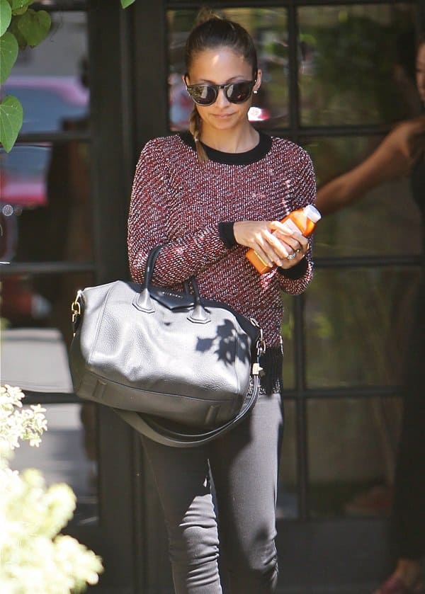 Nicole Richie styles a purple long-sleeved top with black skinny jeans