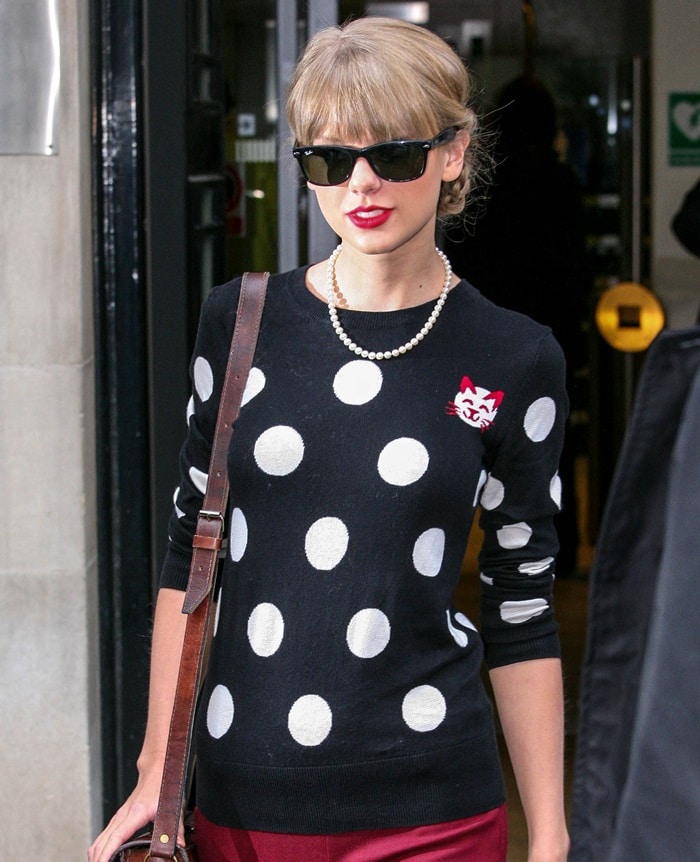 Taylor sporting a French Connection ‘Polka Dot’ sweater and Theory pants in London on November 7, 2012