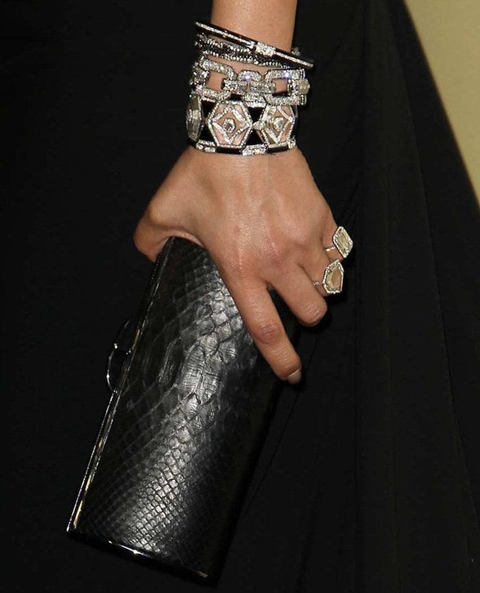 A closer look at Jen's black snakeskin barrel hard case clutch and jewelry