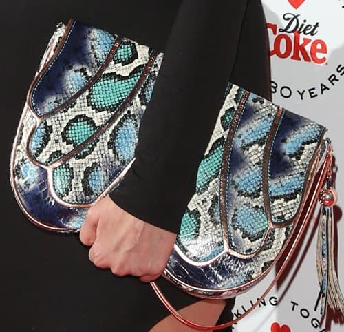Francesca Hull totes an exotic snakeskin purse