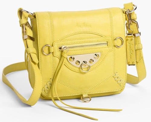Sport a casual classic done up in soft leather with spiky hardware, whipstitching and a swingy zip tassel