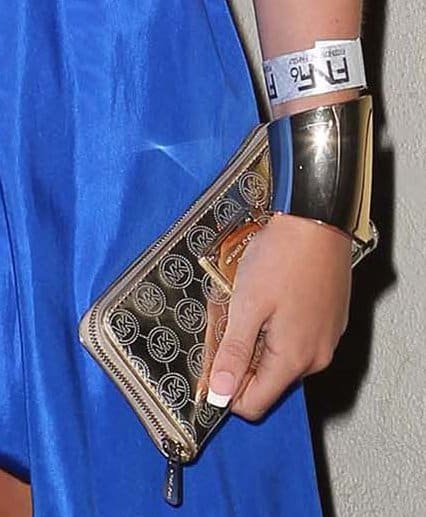 Alli Simpson's gold Michael Kors "Mirror Monogram" clutch