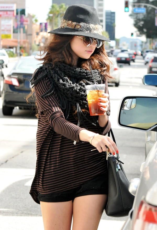 Selena Gomez wears a Forever 21 feather-trimmed wool fedora outside Panera Bread in Encino
