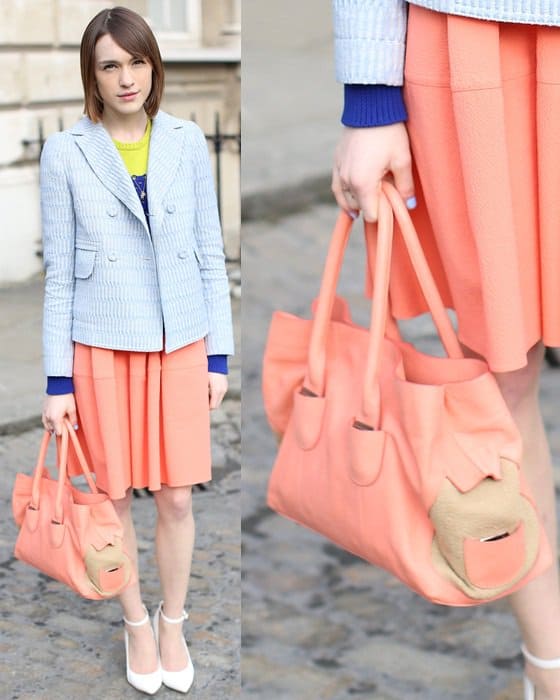 Pretty model carrying a coral-colored handbag
