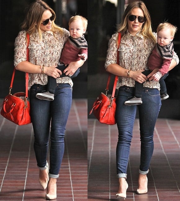 Hilary Duff carrying a red Louis Vuitton 'Speedy Bandouliere' and baby Luca