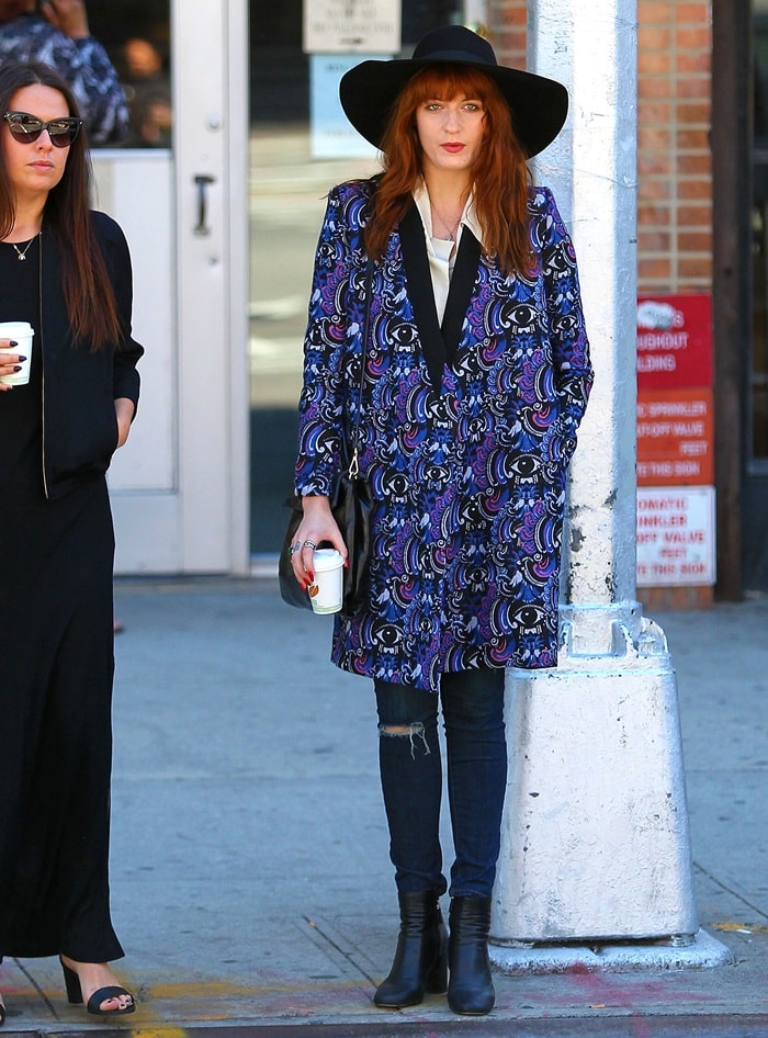 Florence Welch wore a paisley-printed coat and jeans, which she accessorized with a wide-brimmed floppy hat and a Miu Miu Vitello handbag
