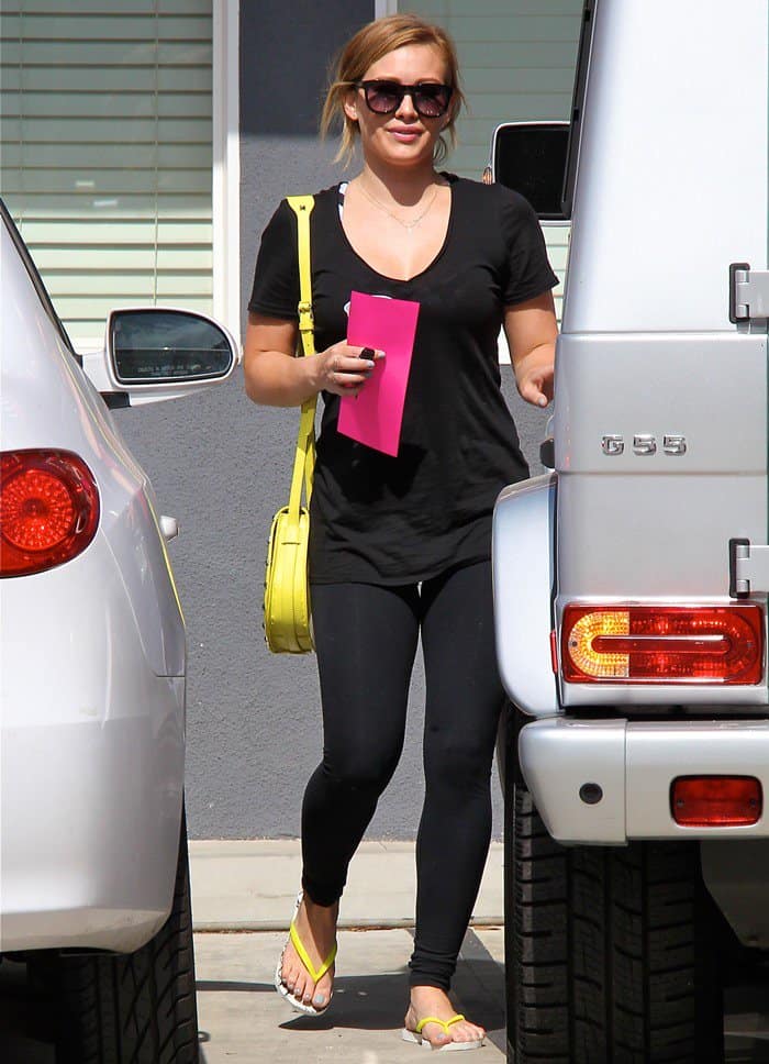 Hilary Duff smiling as she leaves her Pilates class carrying a Rebecca Minkoff 'Skylar' bag in Los Angeles, California on May 24, 2013