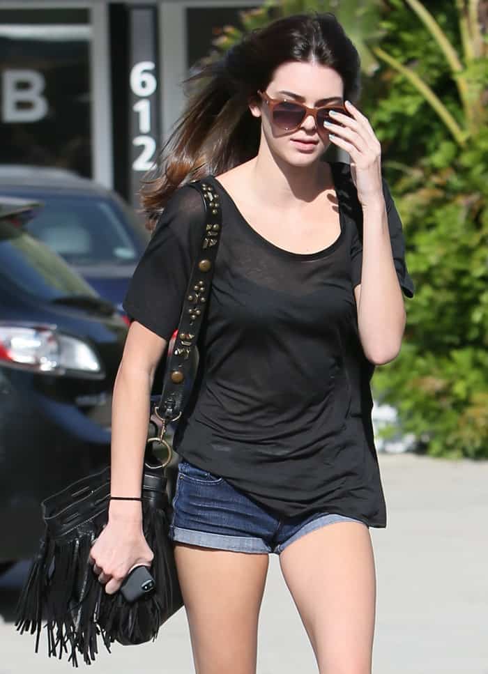 Kendall Jenner carries a fringed McFadin shoulder bag while leaving Andy LeCompte Salon in Los Angeles, California on May 24, 2013