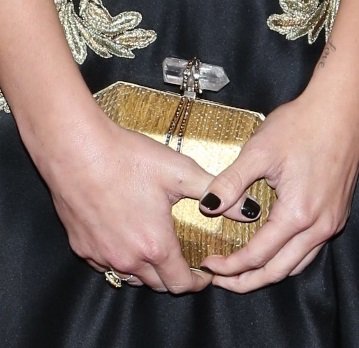 Ashley Greene's gold hardcase clutch