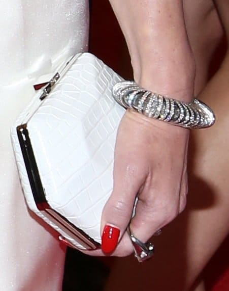 Gwen finished her gown with a white croc-embossed clutch