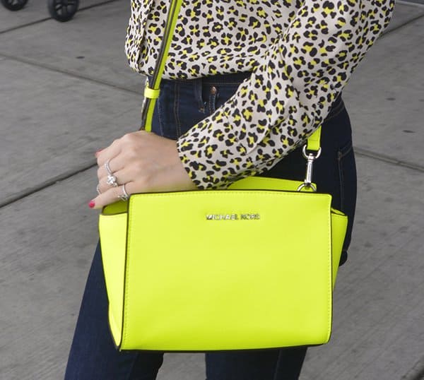 Miranda Kerr carrying a neon yellow Michael Kors 'Selma' messenger bag