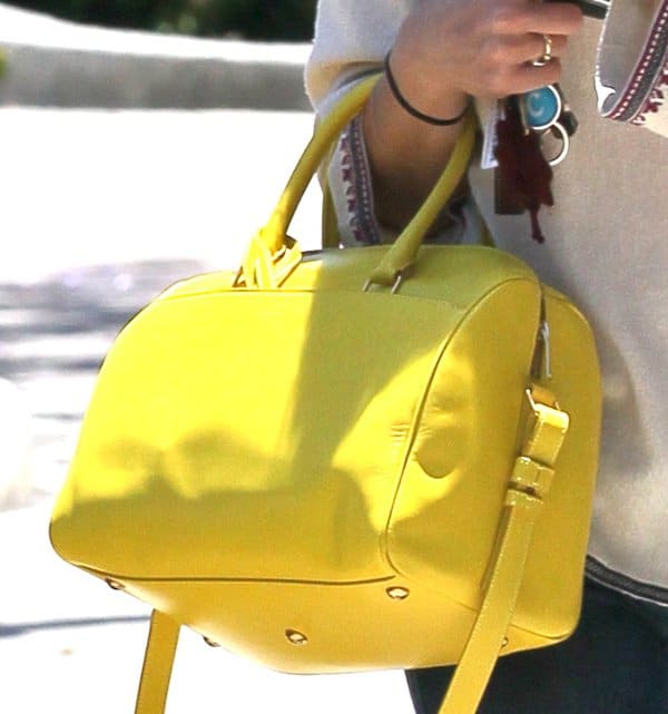 Selma Blair toting a yellow Saint Laurent small rigid crossbody duffle bag