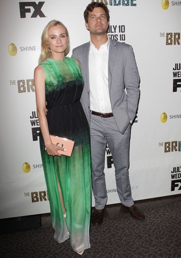 Diane Kruger posing with Joshua Jackson in a Jonathan Saunders dress and with a Charlotte Olympia clutch
