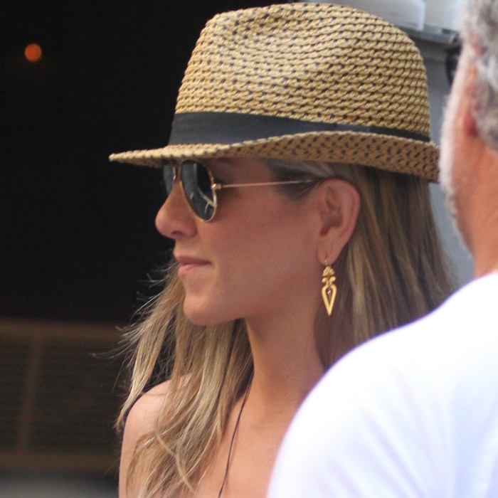Jennifer Aniston wearing Ray-Ban Aviator sunglasses while filming on a hot day