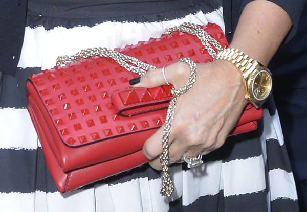 Kris Jenner carrying a Valentino Rock Stud Chain Flap Bag in Rogue