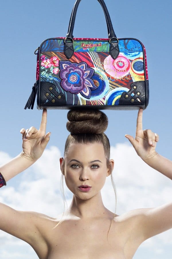 Behati Prinsloo modeling Desigual bags on her head for the brand's Fall/Winter 2012–2013 campaign