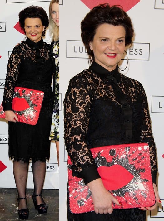Lulu Guinness carrying an oversized clutch from her own line