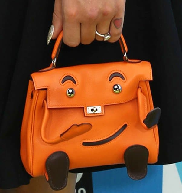 Kelly Osbourne's vintage Hermès handbag featuring a smiley face