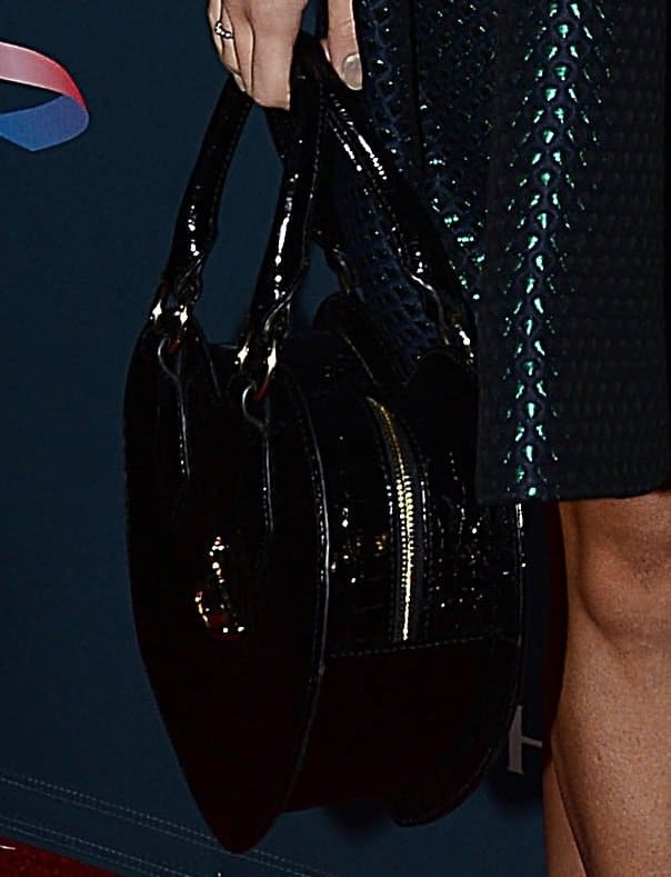 Sukie Waterhouse carrying a Vivienne Westwood frilly snake-print heart handbag