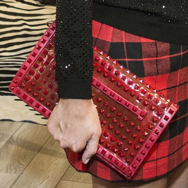Nicky Hilton carrying a Valentino Rockstud rouge patent clutch