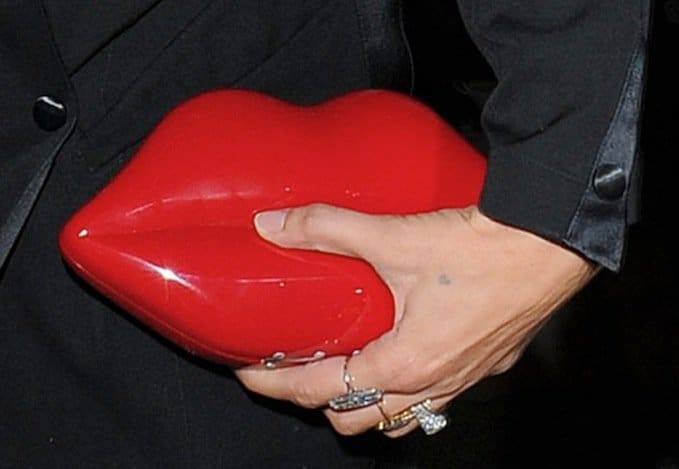 Kate Moss totes by Lulu Guinness' iconic hot red Lips clutch bag