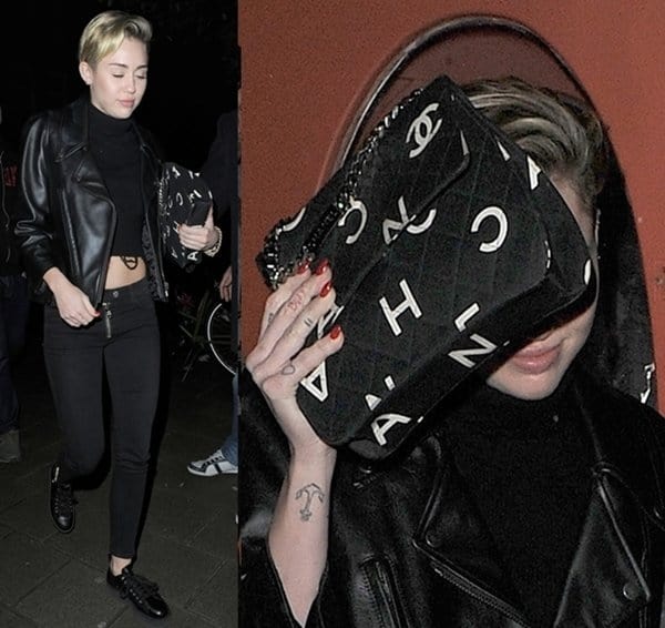 Miley Cyrus holds up her Chanel handbag in Amsterdam
