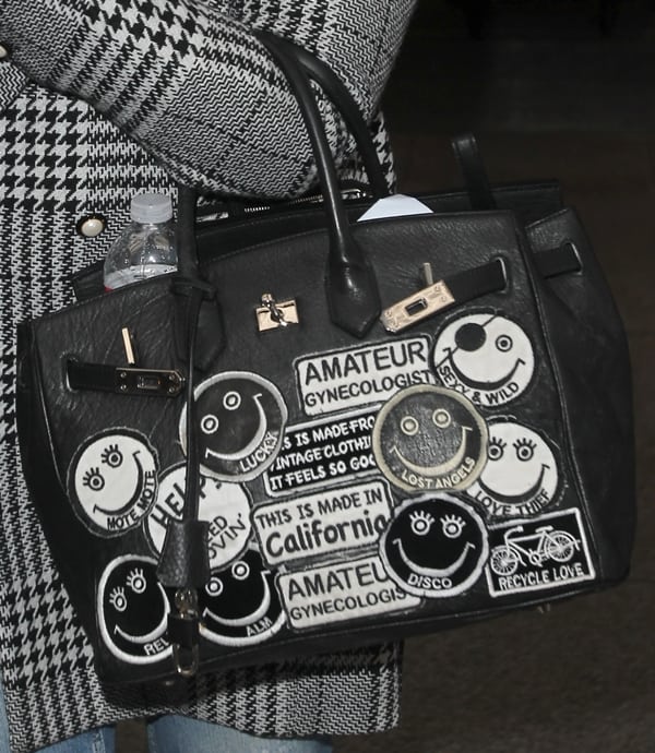 Kelly Osbourne's Birkin bag with stitched patches of smileys and funny quips