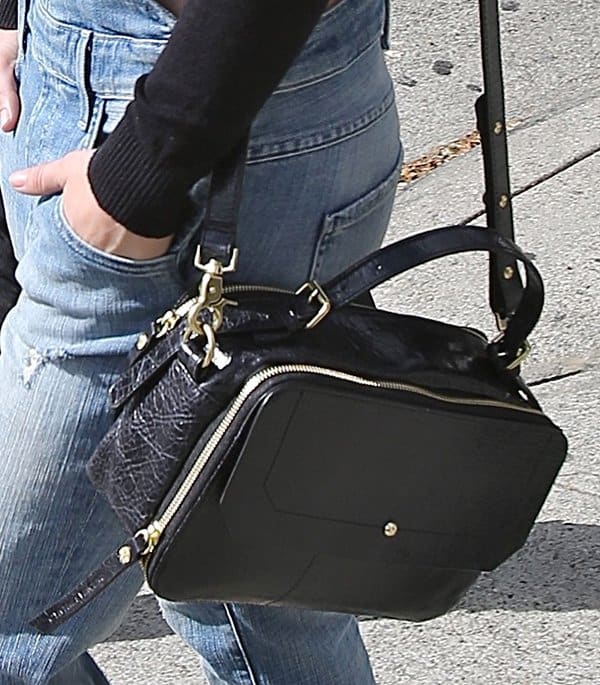 Julianne Hough's square crossbody handbag is a mix between a camera case and a lunchbox