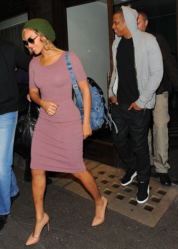 Jay Z in a hoodie, a black shirt, black jeans, and black-and-white kicks