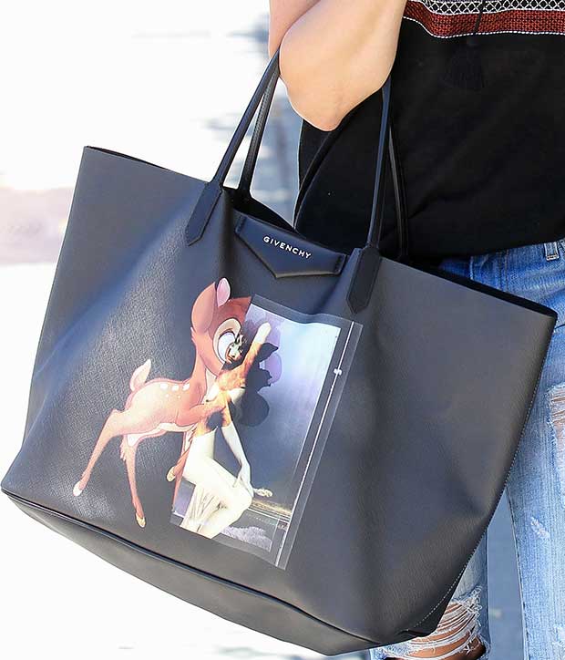 Sophia Bush totes a large Antigona shopping bag in black coated canvas with Bambi print