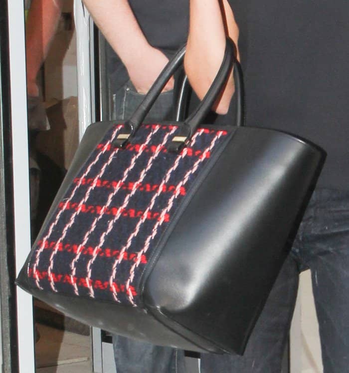 Victoria Beckham totes an embroidered Liberty handbag