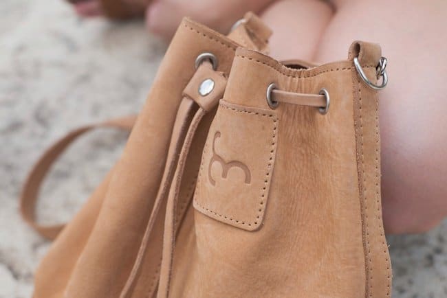 Ewa's safari-inspired brown suede bucket bag