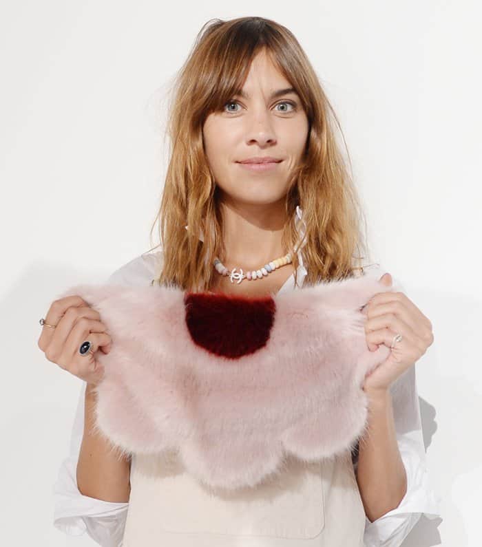 Alexa Chung shows off her pink Shrimps Daisy clutch