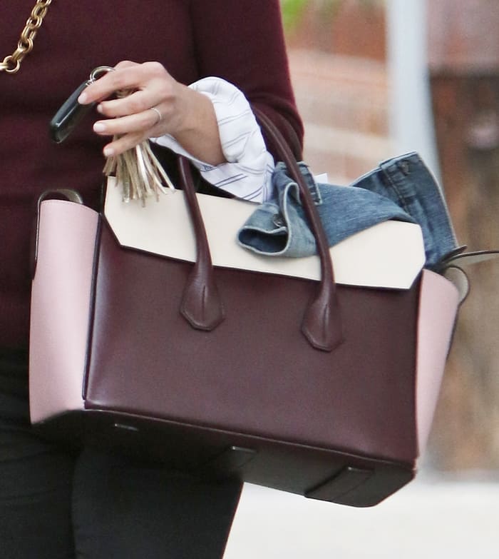 Reese Witherspoon totes a burgundy Bally Sommet Fold tote handbag