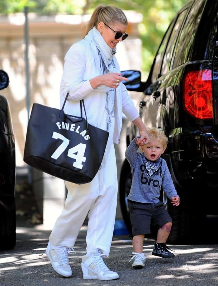 Fergie rocks drop-crotch sweatpants and white wedge-heeled sneakers