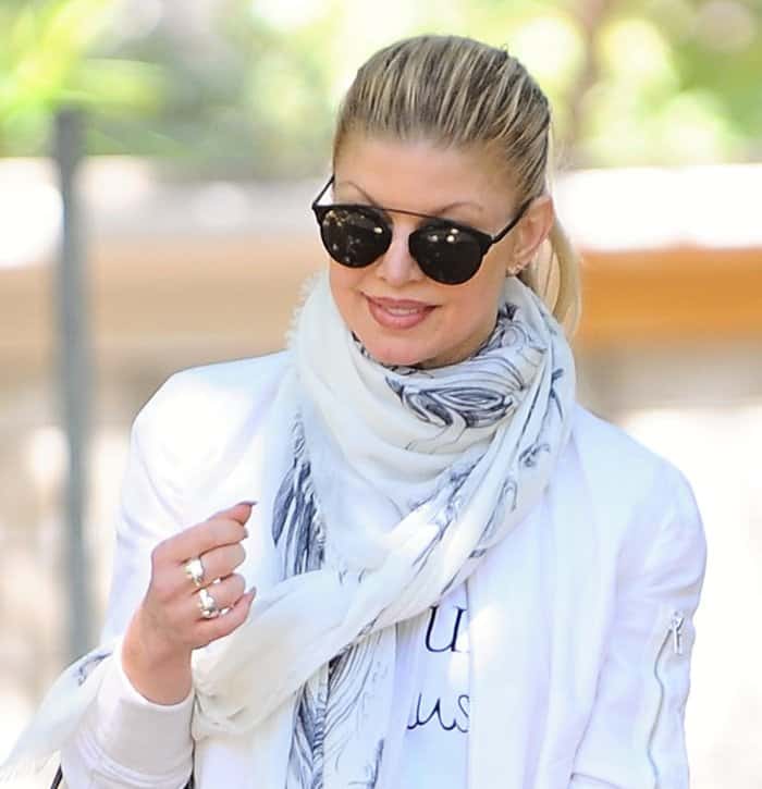 Fergie styled a white fringed scarf with a white zip-up jacket over a white T-shirt