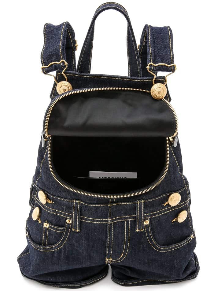 This playful, dark denim Moschino backpack is cut in the shape of overalls and punctuated with luxe gold-tone hardware