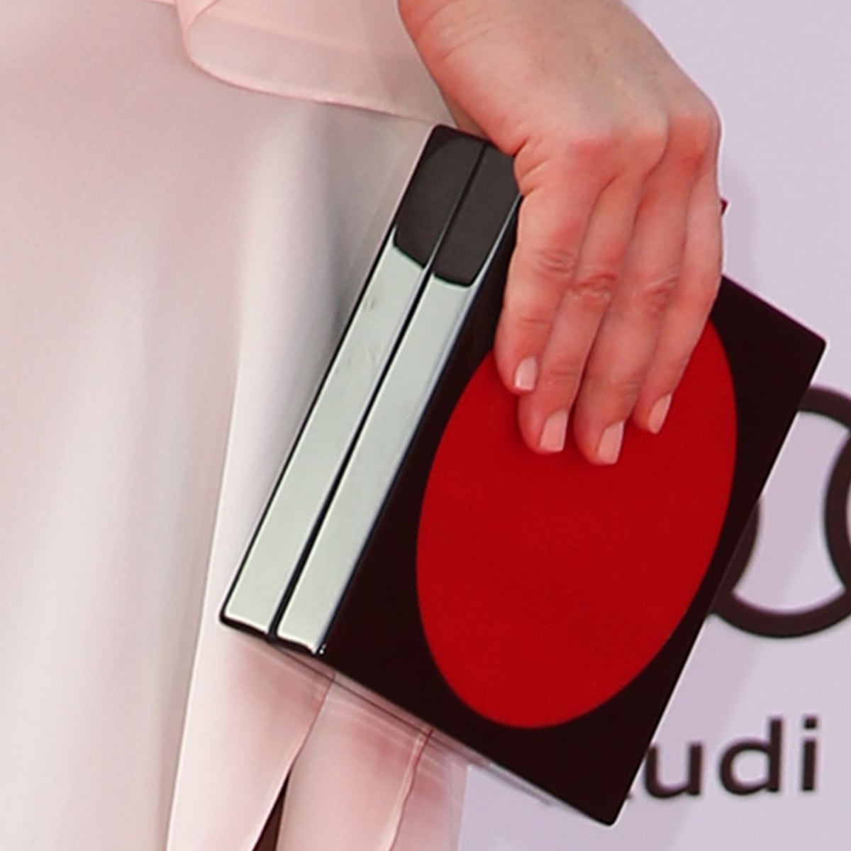 Evangeline Lilly's black and red Les Petits Joueurs clutch with lego clasp detail