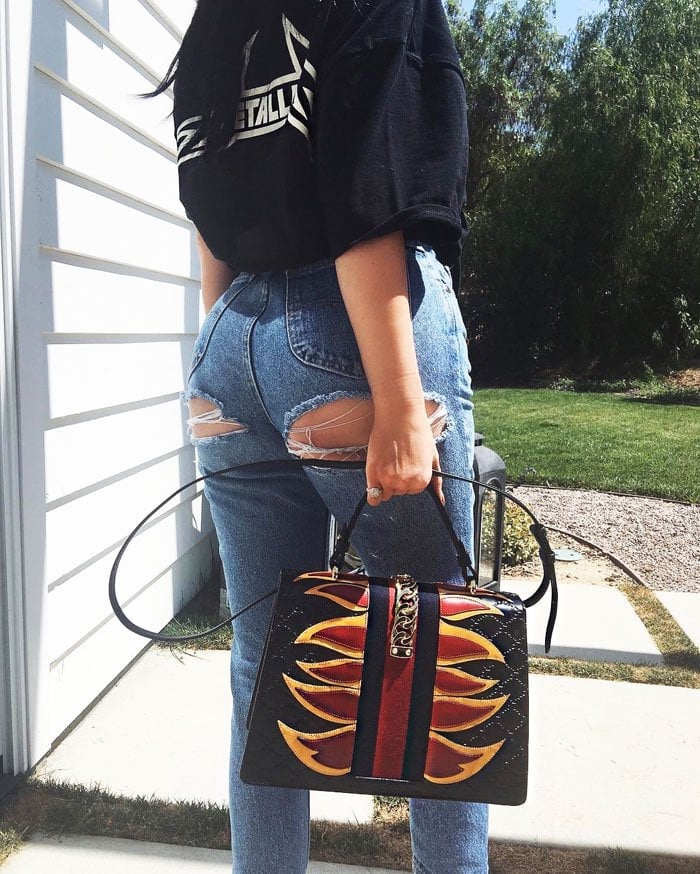 Kylie Jenner shows off her infamous booty with her Gucci "Sylvie" embossed satchel