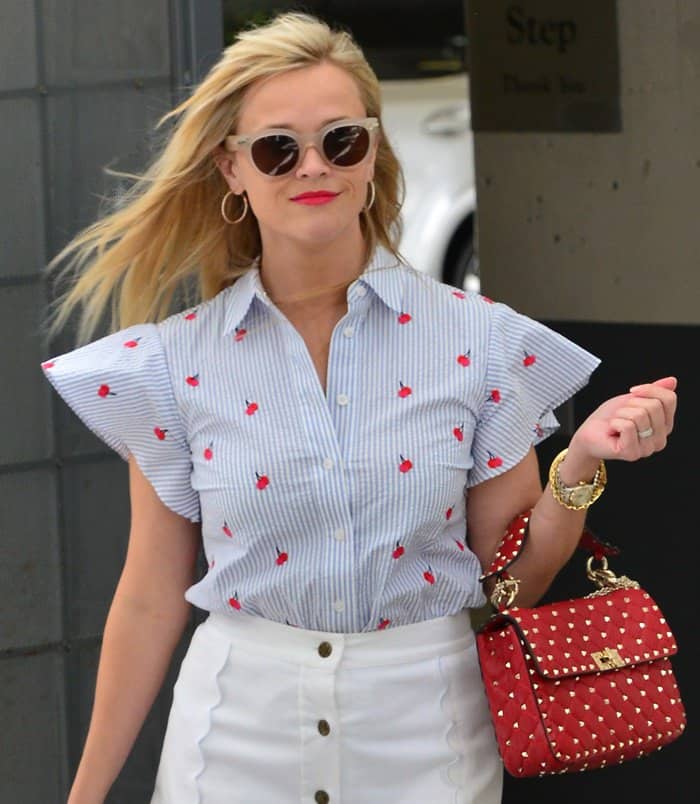 Reese was wearing pieces from her own line Draper James and paired the outfit with a Valentino Rockstud Spike bag