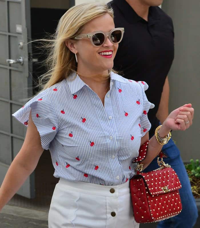Reese was all smiles for the camera as she was photographed leaving her office.