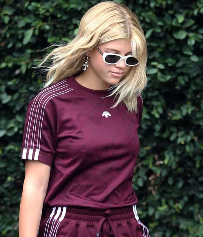 Sofia also paired her Adidas Originals tracksuit with white-framed sunglasses and cross earrings