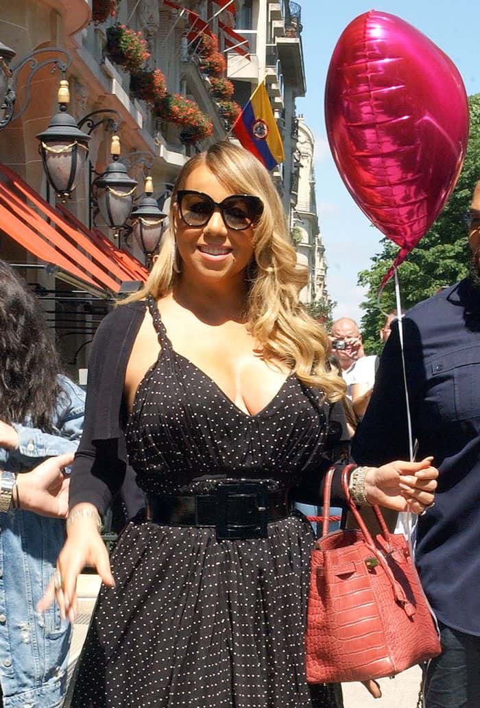 Mariah Carey was photographed carrying a red crocodile Hermes Birkin with a heart balloon tied to it.